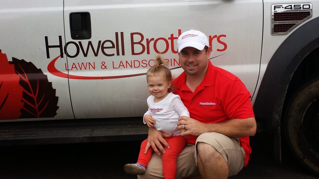 Carl Howell of Howell Brothers Lawn and Landscaping with little helper